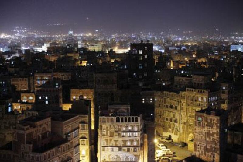 The ancient towers and buildings of Old Sana'a give way to the lights of modern buildings in the Yemeni capital.