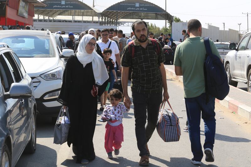 Palestinians wait at the Rafah border crossing between the Gaza Strip and Egypt. AP