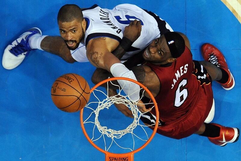 Miami Heat's LeBron James, right, and Dallas Mavericks' Tyson Chandler go after a rebound during the second half of Game 4.