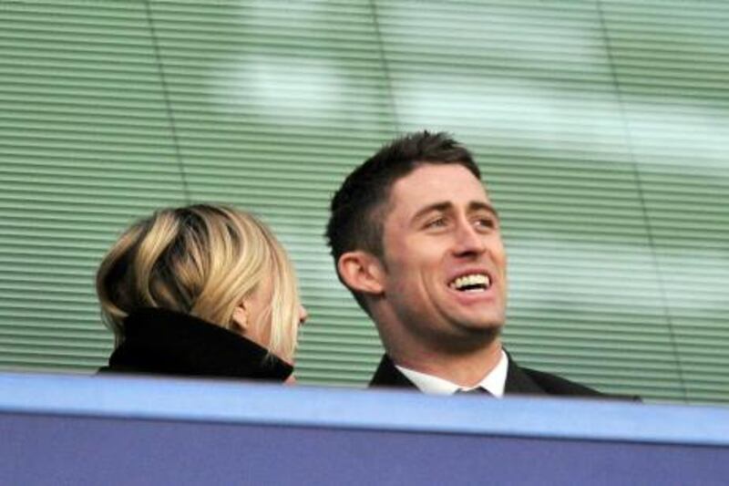 Chelsea's new signing, English defender Gary Cahill (R) watching the game from the stands during the English Premier League football match between Chelsea and Sunderland at Stamford Bridge in London, on January 14, 2012. AFP PHOTO/GLYN KIRK

RESTRICTED TO EDITORIAL USE. No use with unauthorized audio, video, data, fixture lists, club/league logos or “live” services. Online in-match use limited to 45 images, no video emulation. No use in betting, games or single club/league/player publications.
 *** Local Caption ***  642548-01-08.jpg