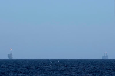 Oil platforms are visible on the horizon off Libya. AP Photo / Petros Karadjias