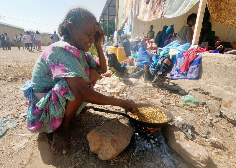 An Ethiopian who fled the ongoing fighting in Tigray region, prepares a meal in Hamdait village on the Sudan-Ethiopia border in eastern Kassala state, Sudan Reuters