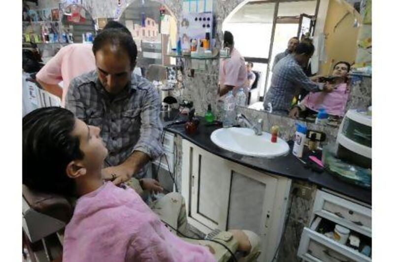 Muharram Salem Sharbet, 27, a volunteer fighter for the National Transitional Council, shaved Saturday for the first time after Qaddafi's death and the impending announcement of the liberation of the country. Ahmed Ibrahim Zhaiter, 38, is the barber shaving him at the famous Shbelia barber shop in Tripoli.
