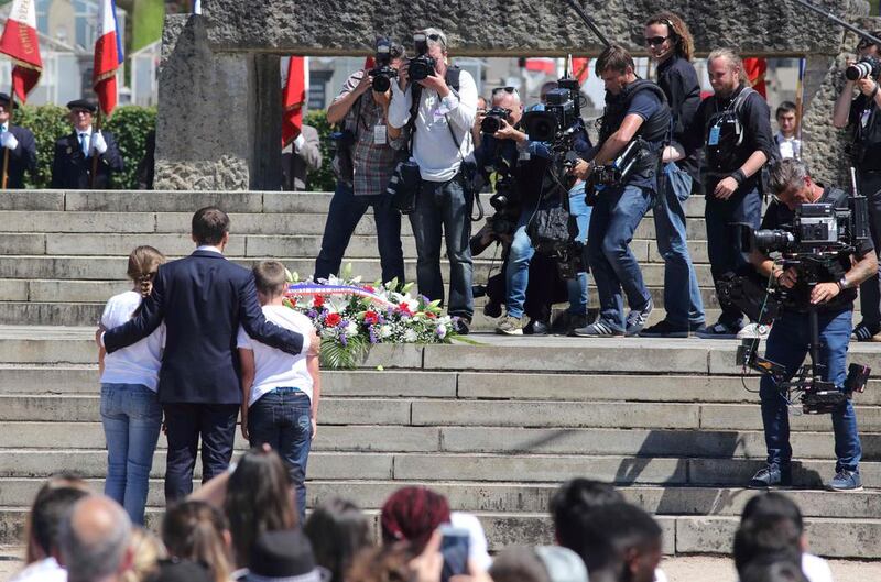 French president Emmanuel Macron, centre, poses as he attends a commemoration ceremony marking the 73rd anniversary of the World War II massacre in Oradour-sur-Glane, Haute-Vienne. Pascal Lachenaud / AFP