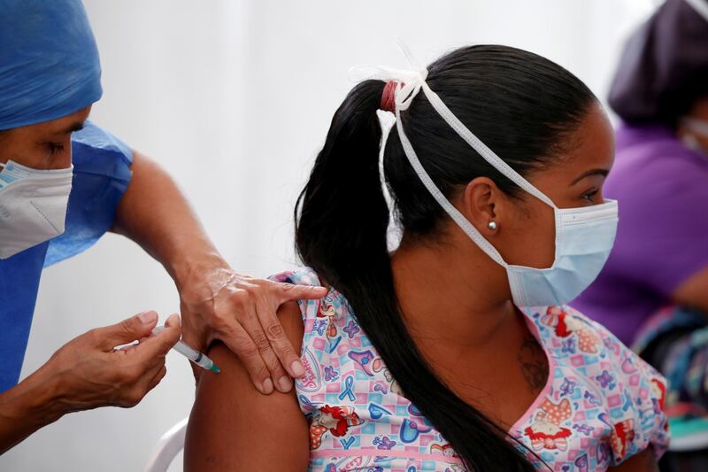 A medical worker receives a dose of China's Sinopharm coronavirus disease (COVID-19) vaccine on a special vaccination day for healthcare personnel in the municipality of Baruta in Caracas, Venezuela May 28, 2021. REUTERS/Leonardo Fernandez Viloria