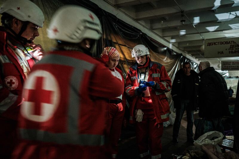 Members of the Ukrainian Red Cross before moving an elderly woman to an ambulance in a bunker at a factory in Severodonetsk, eastern Ukraine. AFP