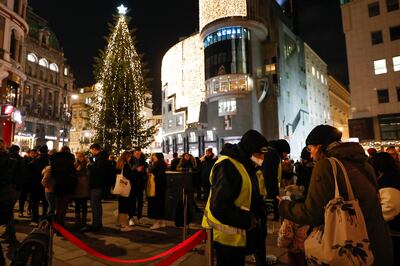 Security guards check vaccination passes at the entrance to a Christmas market in Vienna, Austria. AP 