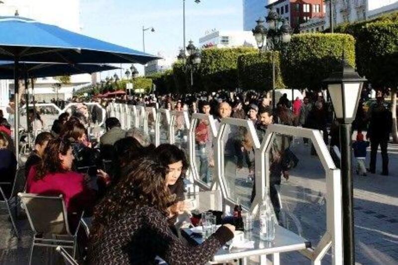 Tunisian women sit at a cafe's terrace in Tunis. REUTERS/Anis Mili