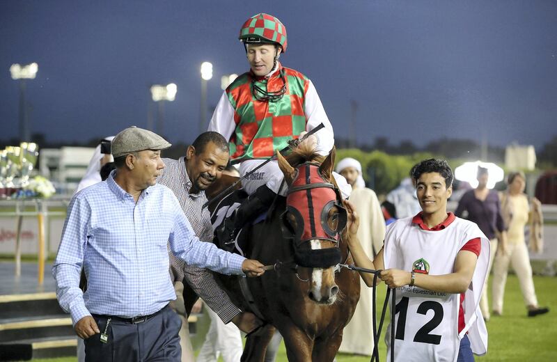 ABU DHABI, UNITED ARAB EMIRATES , March 14  – 2020 :- Patrick Cosgrave  (no 12) guides SOMOUD (FR) to win the 4th horse race Emirates Championship, 2200M at the Abu Dhabi Equestrian Club in Abu Dhabi. (Pawan Singh / The National) For Sports. Story by Amith