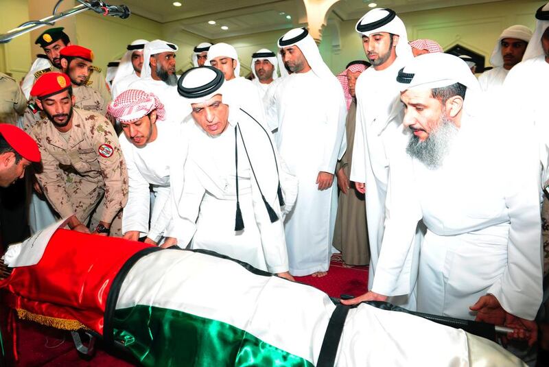 Sheikh Saud bin Saqr Al Qasimi, Ruler of Ras Al Khaimah, helps lay down the body of Ahmed Abdulrahman Al Tunaiji at Sheikh Zayed Mosque in RAK. Wam