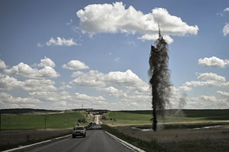 A mortar explodes next to a road leading to the city of Lysychansk, in the eastern Ukrainian region of Donbas. AFP