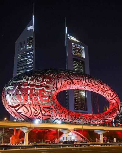 This picture taken on February 6, 2021 shows a view of the Museum of the Future in Dubai, lit red ahead of the UAE's "Al-Amal" -- Arabic for "Hope" -- probe's arrival in Mars' orbit, in what is considered the most critical part of the journey to the Red Planet. The unmanned probe -- named "Al-Amal" -- Arabic for "Hope" -- blasted off from Japan last year, marking the next step in the United Arab Emirates' ambitious space programme.  / AFP / Giuseppe CACACE
