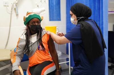 A person receives their Covid-19 vaccination as a 24-hour "jabathon" takes place at an overnight walk-in vaccine clinic in the UK. PA