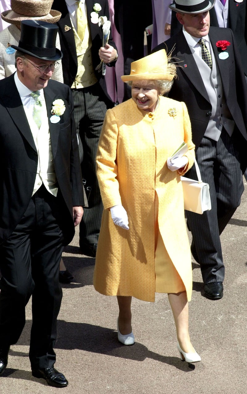 Queen Elizabeth II, wearing yellow, walks to the Royal Enclosure June 21, 2001 at Ascot Racecourse in Ascot, England. Getty Images