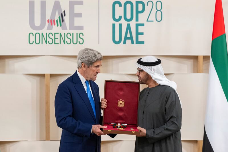 Sheikh Mohamed awards the First Class Order of Zayed II medal to John Kerry, former US presidential climate envoy. Abdulla Al Neyadi / Presidential Court