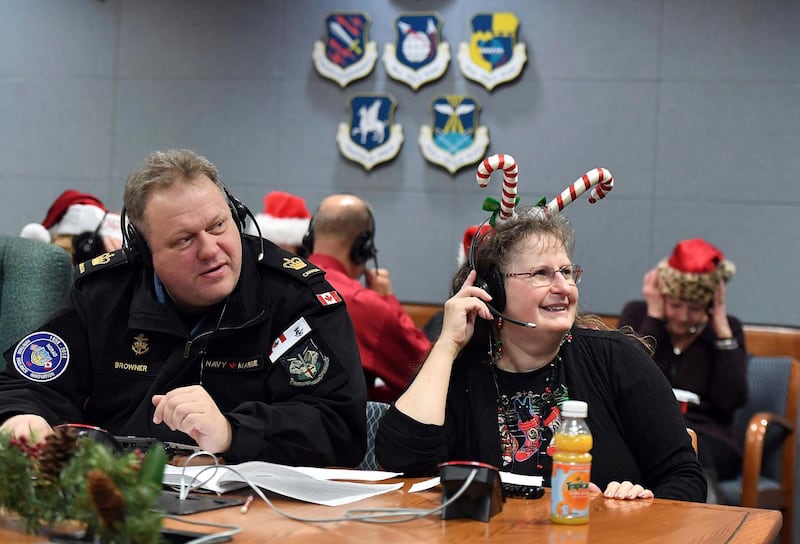 Canadians Eileen Browner and her husband, Canadian Royal Navy Petty Officer Robert Browner were two of the more than 1,500 volunteers that answered phone calls from children all over the world, at the annual NORAD Tracks Santa Operations Center at Peterson Air Force Base. AP