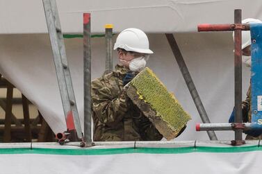  Army officers wearing combat uniforms are seen removing what is believed to be part of the roof at the house of former Russian spy Sergei Skripal in Christie Miller Road in Salisbury, Britain. EPA