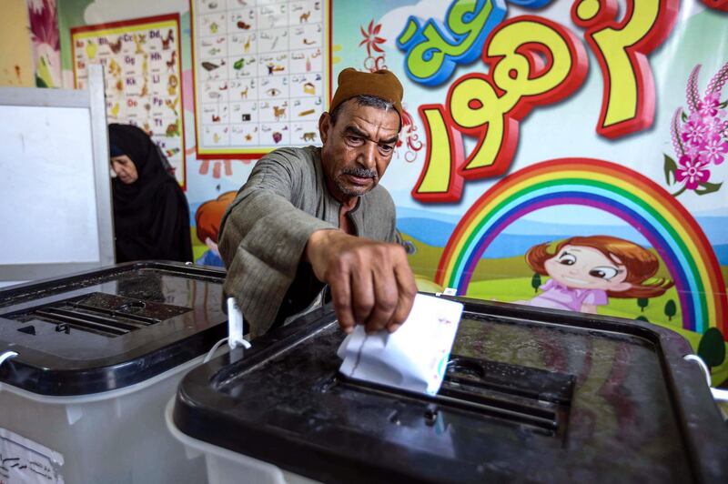 A man casts his ballot at a polling station in El Ayyat, south of the Egyptian capital, during the first stage of the lower house elections. AFP