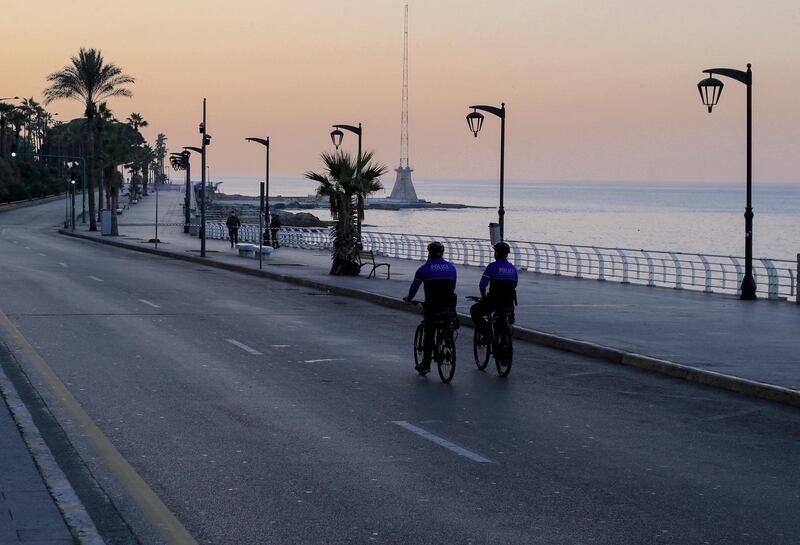 Beirut municipality police patrol the empty roads in the coastal area of Beirut, Lebanon.  EPA