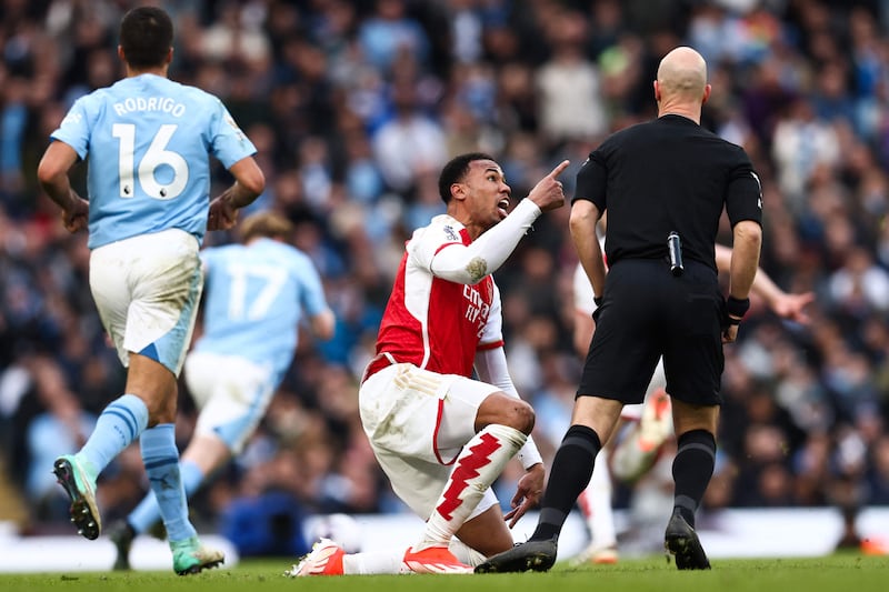 Arsenal defender Gabriel Magalhaes argues with referee Anthony Taylor. AFP