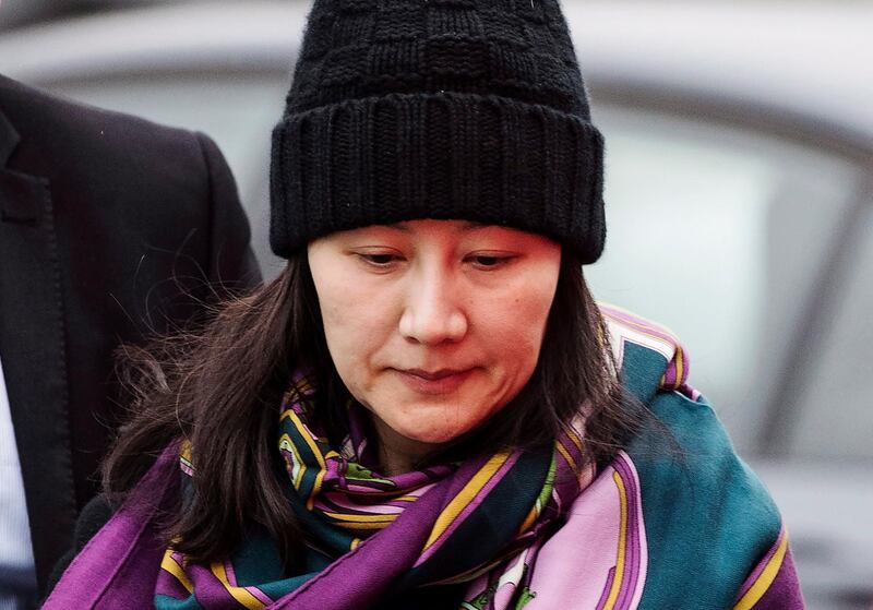 FILE - In this Dec. 12, 2018, file photo, Huawei chief financial officer Meng Wanzhou arrives at a parole office with a security guard in Vancouver, British Columbia. China on Tuesday, Jan. 22, 2019, demanded the U.S. drop a request that Canada extradite the top executive of the tech giant Huawei, shifting blame to Washington in a case that has severely damaged Beijingâ€™s relations with Ottawa. (Darryl Dyck/The Canadian Press via AP, File)