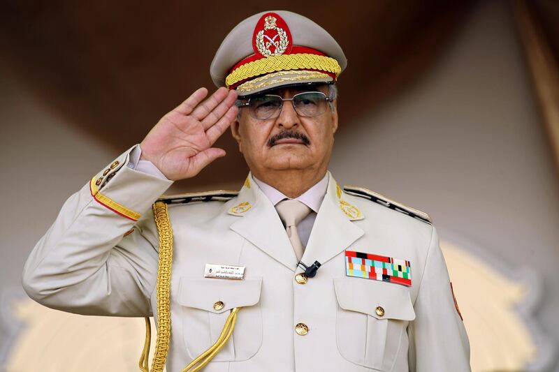 (FILES) In this file photo taken on May 7, 2018, Libyan Strongman Khalifa Haftar salutes during a military parade in the eastern city of Benghazi, during which he announced a military offensive to take from "terrorists" the city of Derna, the only part of eastern Libya outside his forces' control. Libyan strongman Khalifa Haftar, whose forces have been battling to capture the seat of the UN-recognised government in Tripoli since April 2019, has said he is open to dialogue after repeatedly rejecting UN calls for talks. "When all is said and done, we need dialogue and we need to sit down" at the negotiating table, Hafar said in a statement issued late on September 25 on the eve of a special session on Libya on the sidelines of the UN General Assembly in New York. / AFP / Abdullah DOMA
