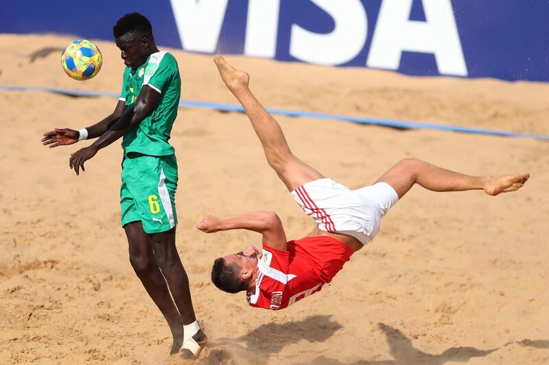 Russia's Boris Nikonorov, right, goes for the spectacular against Senegal at the Beach Soccer World Cup in Luque, Paraguay, on Friday, November 22. EPA