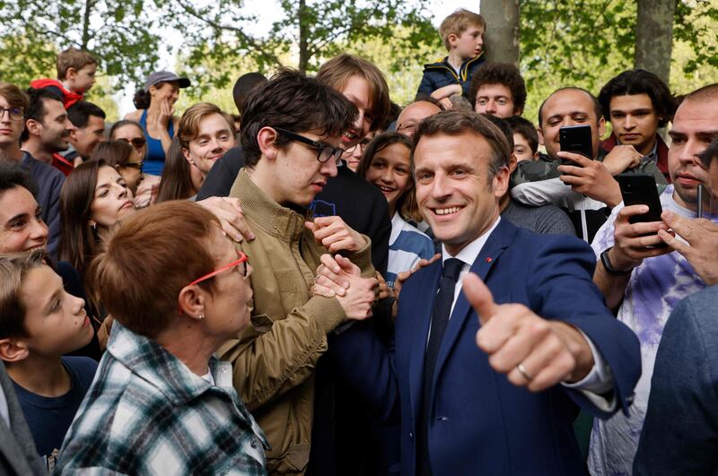France’s President Emmanuel Macron, La Republique en Marche’s candidate for re-election, greets supporters on April 18, 2022. AFP