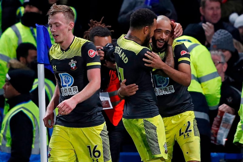 Southampton's English midfielder Nathan Redmond (R) celebrates with Southampton's English midfielder Nathan Redmond (C) after scoring their second goal during the English Premier League football match between Chelsea and Southampton at Stamford Bridge in London on December 26, 2019. Southampton won the game 2-0. - RESTRICTED TO EDITORIAL USE. No use with unauthorized audio, video, data, fixture lists, club/league logos or 'live' services. Online in-match use limited to 120 images. An additional 40 images may be used in extra time. No video emulation. Social media in-match use limited to 120 images. An additional 40 images may be used in extra time. No use in betting publications, games or single club/league/player publications.
 / AFP / Adrian DENNIS / RESTRICTED TO EDITORIAL USE. No use with unauthorized audio, video, data, fixture lists, club/league logos or 'live' services. Online in-match use limited to 120 images. An additional 40 images may be used in extra time. No video emulation. Social media in-match use limited to 120 images. An additional 40 images may be used in extra time. No use in betting publications, games or single club/league/player publications.
