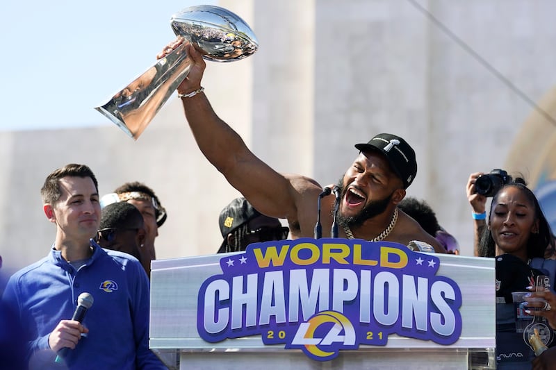 Los Angeles Rams defensive lineman Aaron Donald holds up the Vince Lombardi Super Bowl trophy during the team's victory celebration. AP