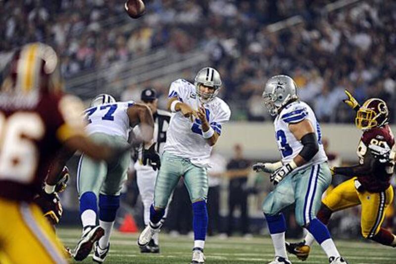 Tony Romo throws during Dallas' 18-16 win against Washington. Romo managed to last all four quarters with a broken rib.