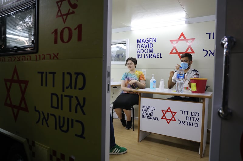 A minor receives a COVID-19 vaccines at a vaccination station in Tel Aviv.