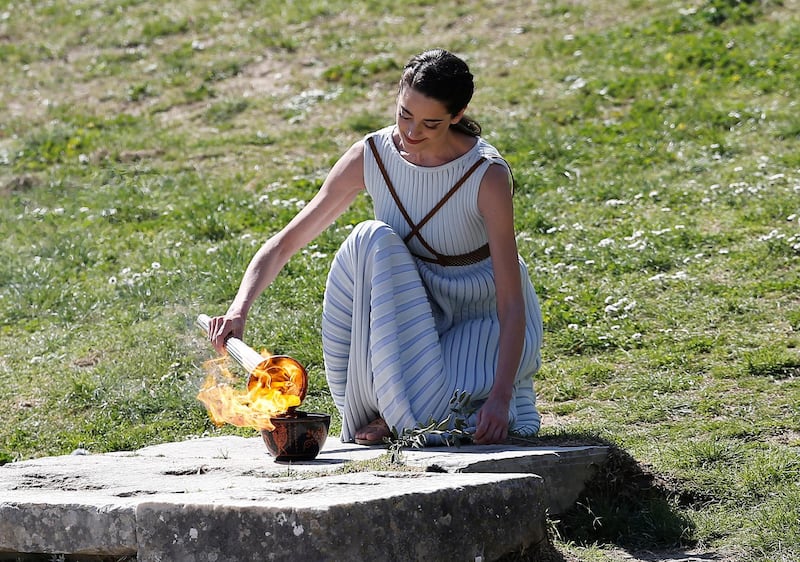 Greek actress Xanthi Georgiou, playing the role of High Priestess lights the flame during the Olympic flame lighting ceremony for the Tokyo 2020 Summer Olympics in Ancient Olympia, Greece. Reuters