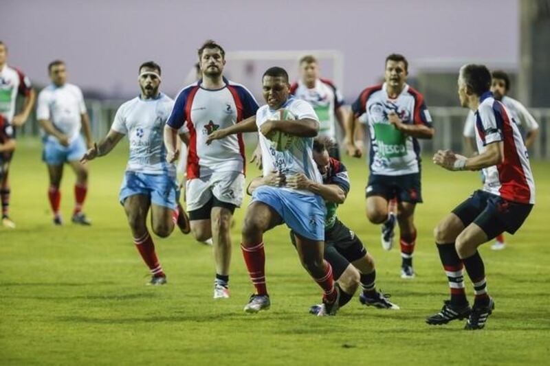 Rugby match between Jebel Ali Dragons (3rd team) vs UAE Shaheen (Light blue and white) at the Sevens Grounds. Omran Al Kindi makes a break. (Photo: Antonie Robertson/The National)