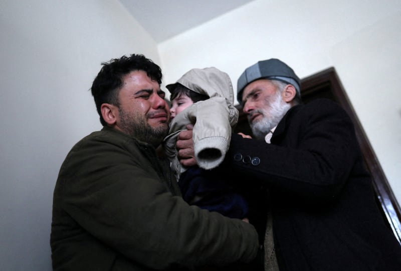 Sohail Ahmadi is handed to his grandfather, Mohammad Qasem Razawi, at Kabul’s international airport. He was found by taxi driver Hamid Safi, 29. Reuters