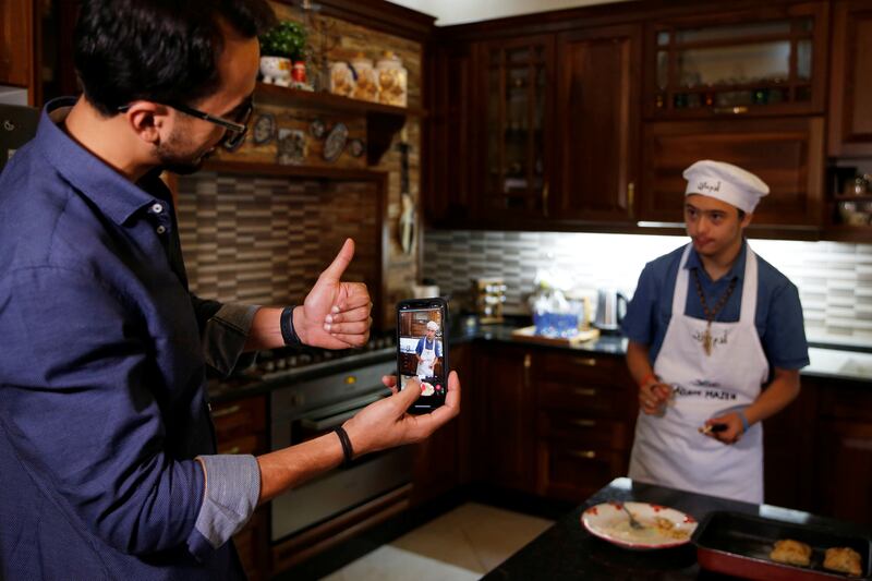 Jordanian Tiktok star Adam Mazen, 17, cooks a meal for his followers as his brother films him at their home in Amman. Reuters