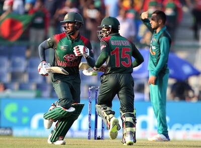 Bangladesh's Mohammad Mithun, left, and Mushfiqur Rahim, center, run between the wickets to score during the one day international cricket match of Asia Cup between Pakistan and Bangladesh in Abu Dhabi, United Arab Emirates, Wednesday, Sept. 26, 2018. (AP Photo/Aijaz Rahi)