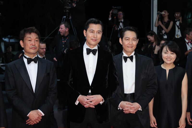 Japanese sportsman Hitoki Iwase, South Korean actors Jung Woo-sung and Lee Jeong-jae, and a guest attend the screening of 'Hunt'. Getty