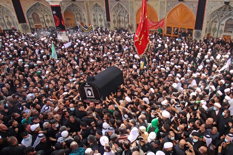 Iraqis carry the coffin of Mohammed Saeed Al Hakim during his funeral in Najaf. AFP