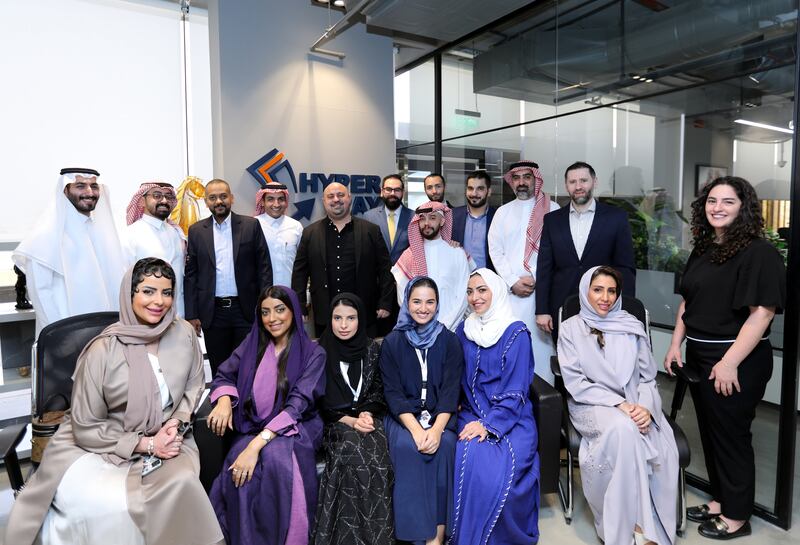 Muhannad Ebwini, back row centre, with his team at HyperPay. The founder and chief executive says the company is 'very excited' about the prospects of its initial public offering: Photo: HyperPay