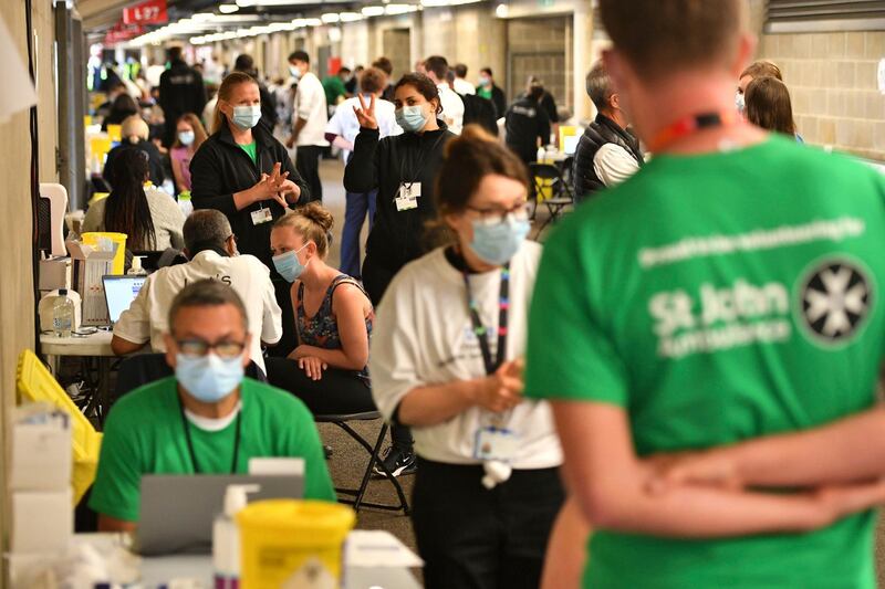 People queue up to receive a coronavirus vaccination. AP Photo