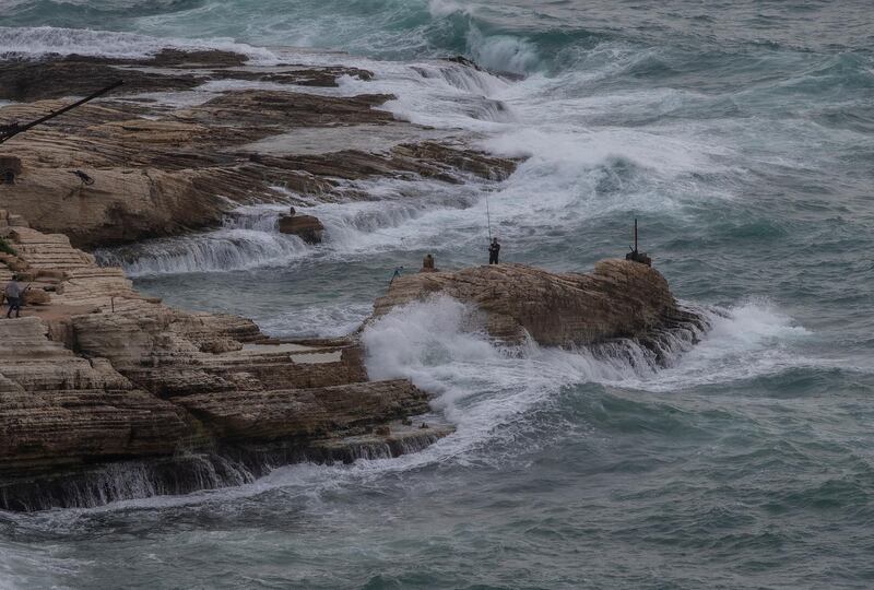 Men fish on the sea front on the Mediterranean coast in Beirut, Lebanon. EPA