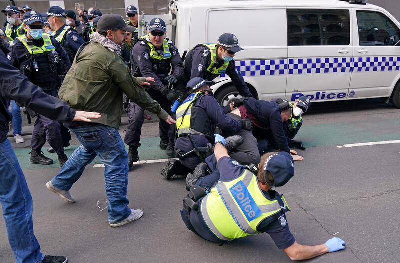 Protesters opposed to lockdown measures implemented to curb the spread of the coronavirus disease (COVID-19) clash with police outside Parliament House in Melbourne, Australia. REUTERS