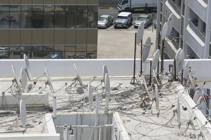 A maximum of four satellite dishes connected to a central system can be installed on roofs by building owners, according to Abu Dhabi Municipality rules. Mona Al-Marzooqi / The National