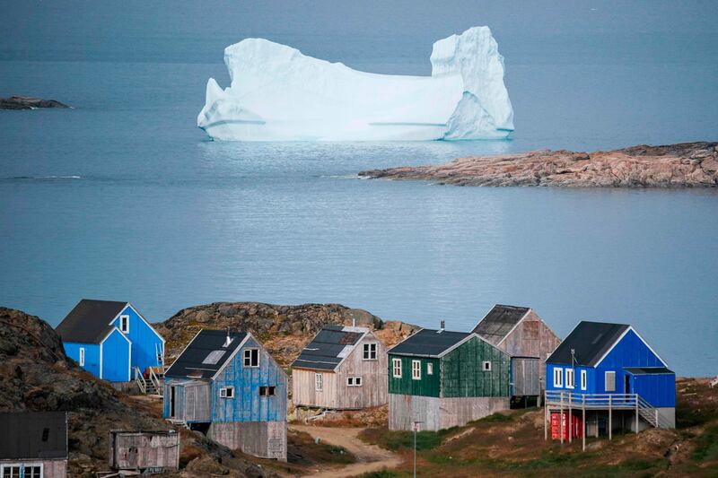 TOPSHOT - Icebergs float behind the town of Kulusuk in Greenland on August 19, 2019. Denmark's prime minister said on August, 21, 2019 she was "annoyed and surprised" that US President Donald Trump postponed a visit after her government said its territory Greenland was not for sale, but insisted their ties remained strong. / AFP / Jonathan NACKSTRAND
