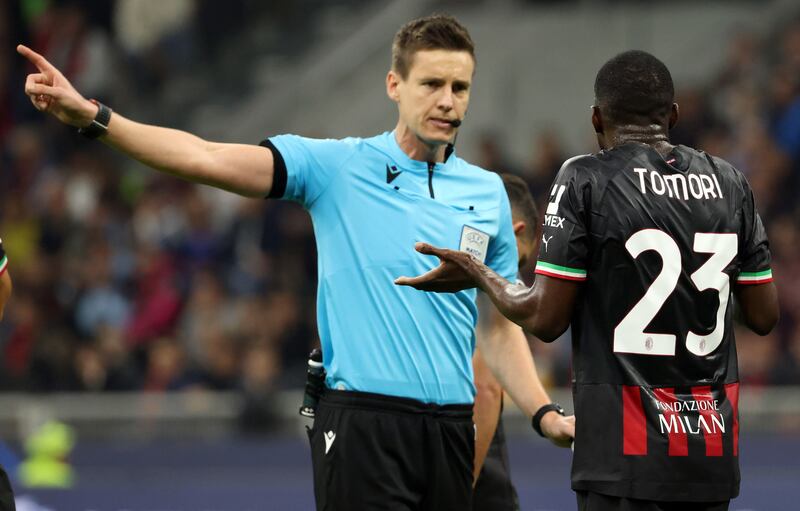 Referee Daniel Siebert sends off Milan's Fikayo Tomori. EPA