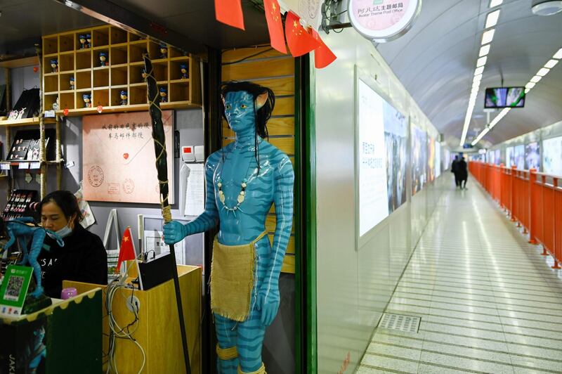 A model of an 'Avatar' character at the gate of a film-themed post office in a passage leading to Bailong Elevators. AFP