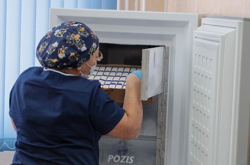 A Russian medical worker takes a trial vaccine from refrigerator to prepare for a volunteer at outpatient hospital number 68 in Moscow on 17. EPA