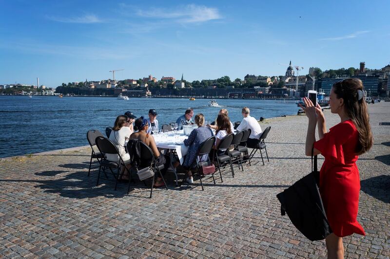 People have a drink after work while following social-distancing rules imposed to limit the spread of the coronavirus disease, in Stockholm, Sweden.  Reuters