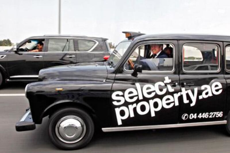 Dubai, April 12, 2012 - Adam Price, Managing Director ME for Select Property drives this 1992 LTI London Taxi, commonly known as the 'Black Hackney', along Sheikh Zayed Road in Dubai City, Dubai April 12, 2012.  (Photo by Jeff Topping/The National) 